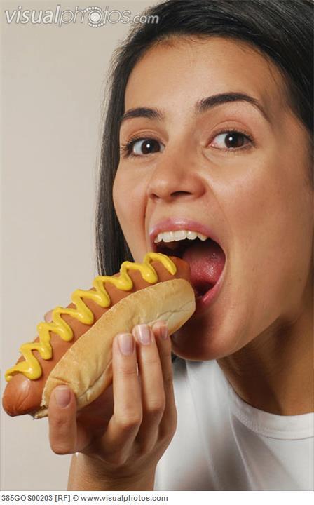 Woman eating hot dog